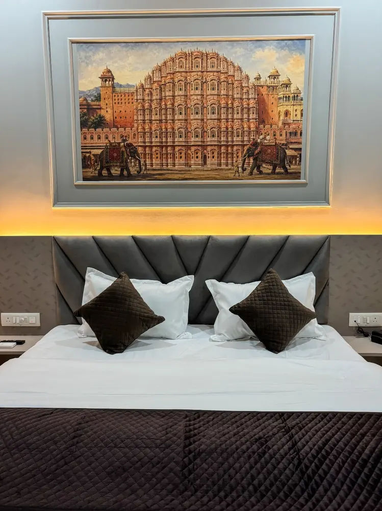 Hawa Mahal painting above an upholstered headboard