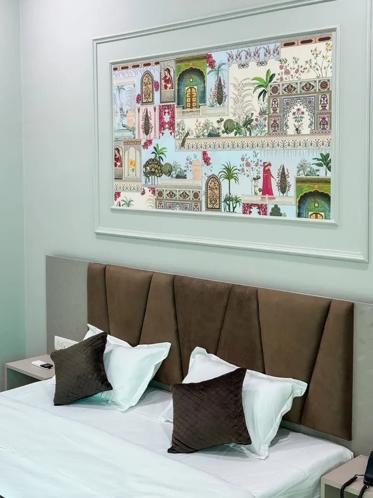 Bed with chevron headboard and Rajasthani mural