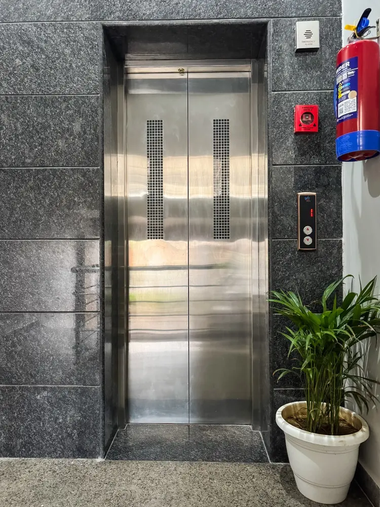Lift lobby with granite cladding and fire extinguisher